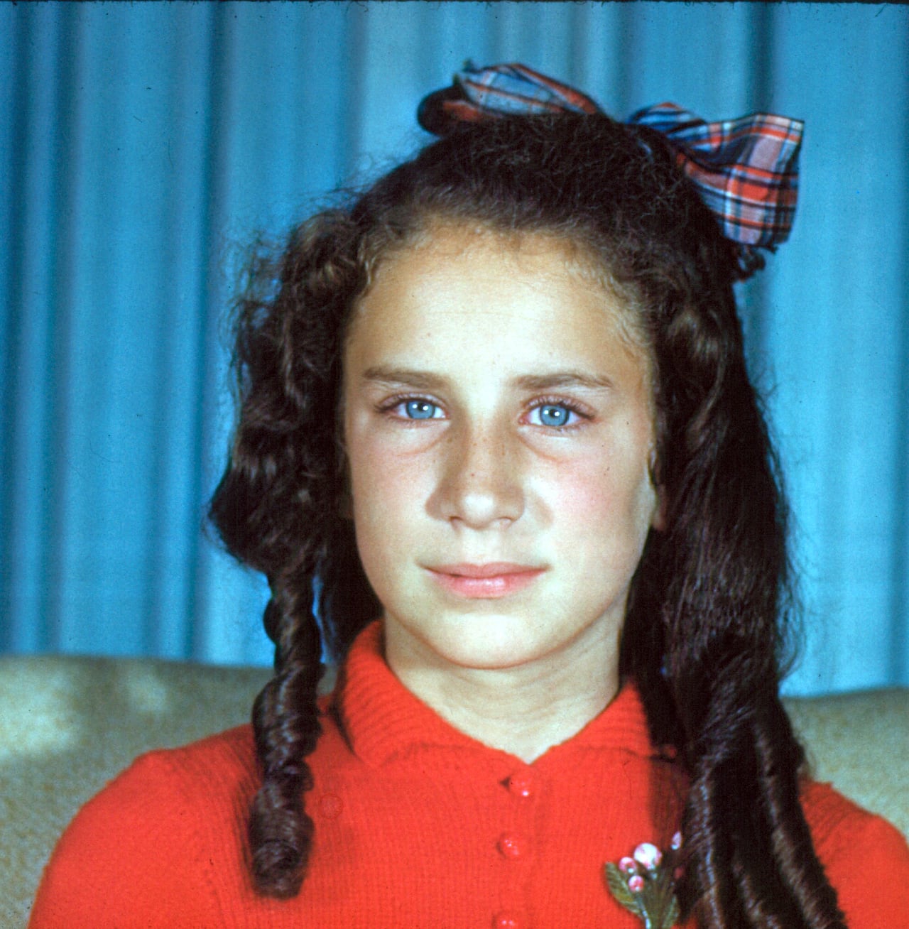 A child looks into the camera for a photograph